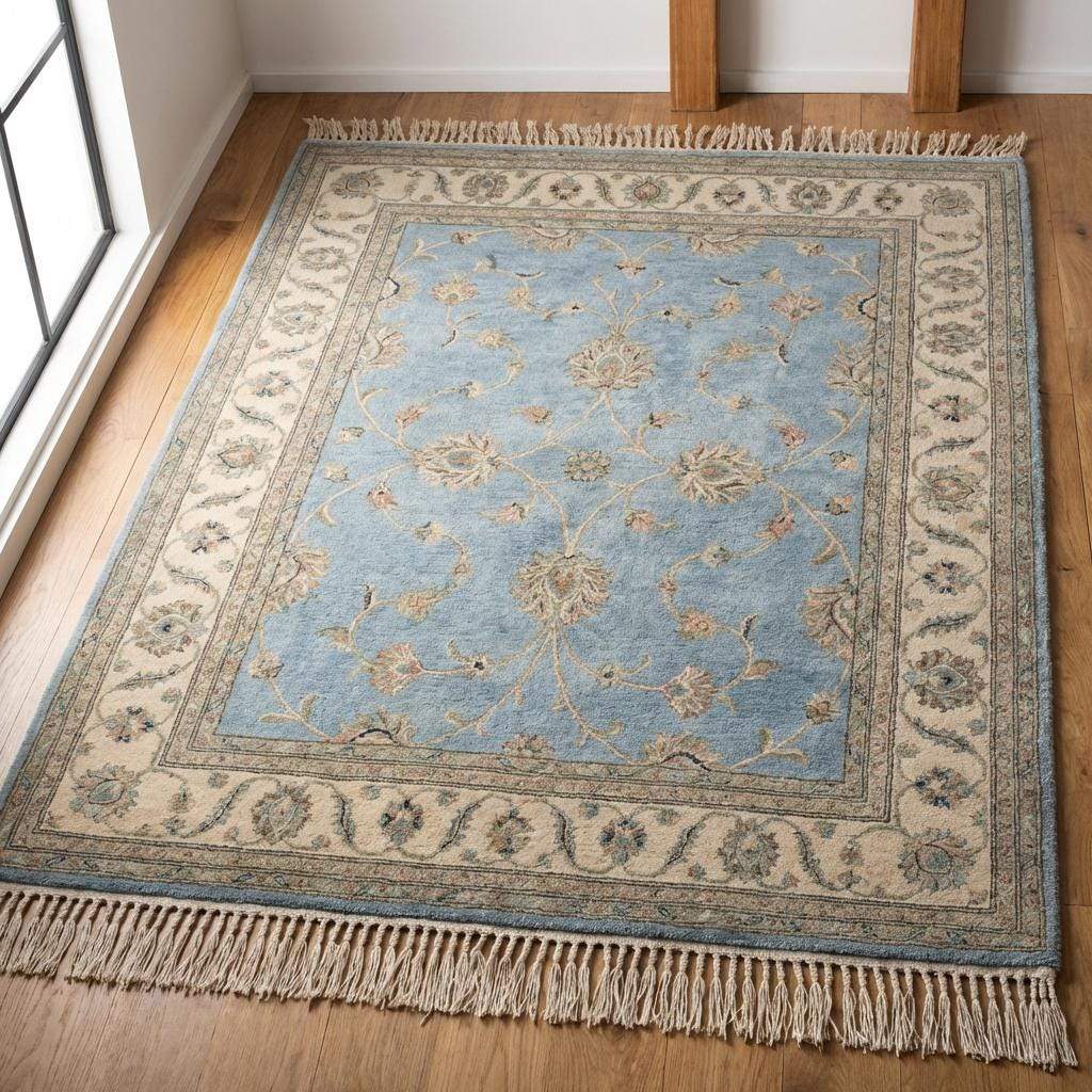 Soft muted blue rug styling for coastal or farmhouse living room decor.