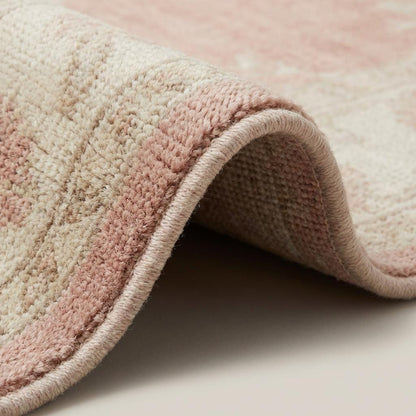 Hand knotted Oushak rug in blush pink with floral medallion, wool area rug for living room and bedroom