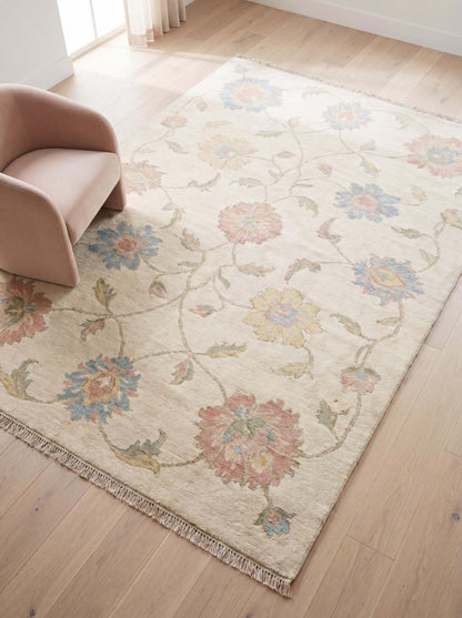 Hand knotted Oushak rug with ivory background and pastel floral vine design in modern living room __etsy:7950282812