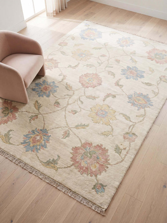 Hand knotted Oushak rug with ivory background and pastel floral vine design in modern living room __etsy:7950282812