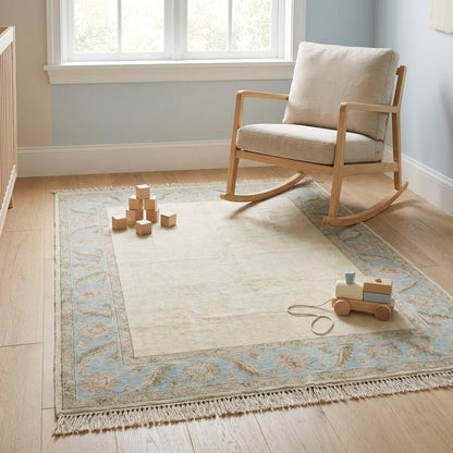 Rectangular handmade wool Persian style rug in calming ivory, sky blue, and dusty rose tones