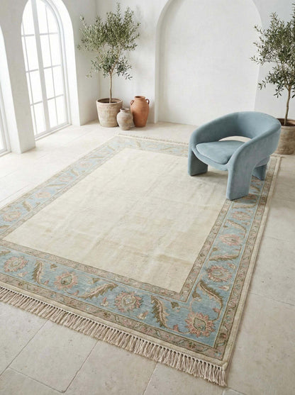 Hand Knotted Oushak Rug with ivory field and blue floral border, handmade wool Persian style area rug, soft neutral living room decor