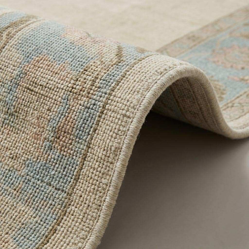 Close-up of dense hand-knotted wool pile showing individual knots, soft natural fibers, and subtle tonal variation