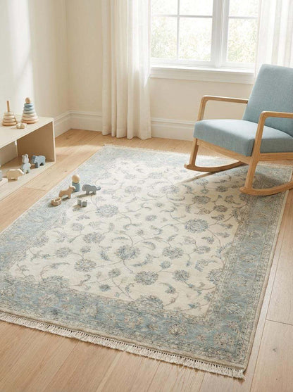 Persian-inspired Oushak rug with low pile wool construction and classic vine motifs