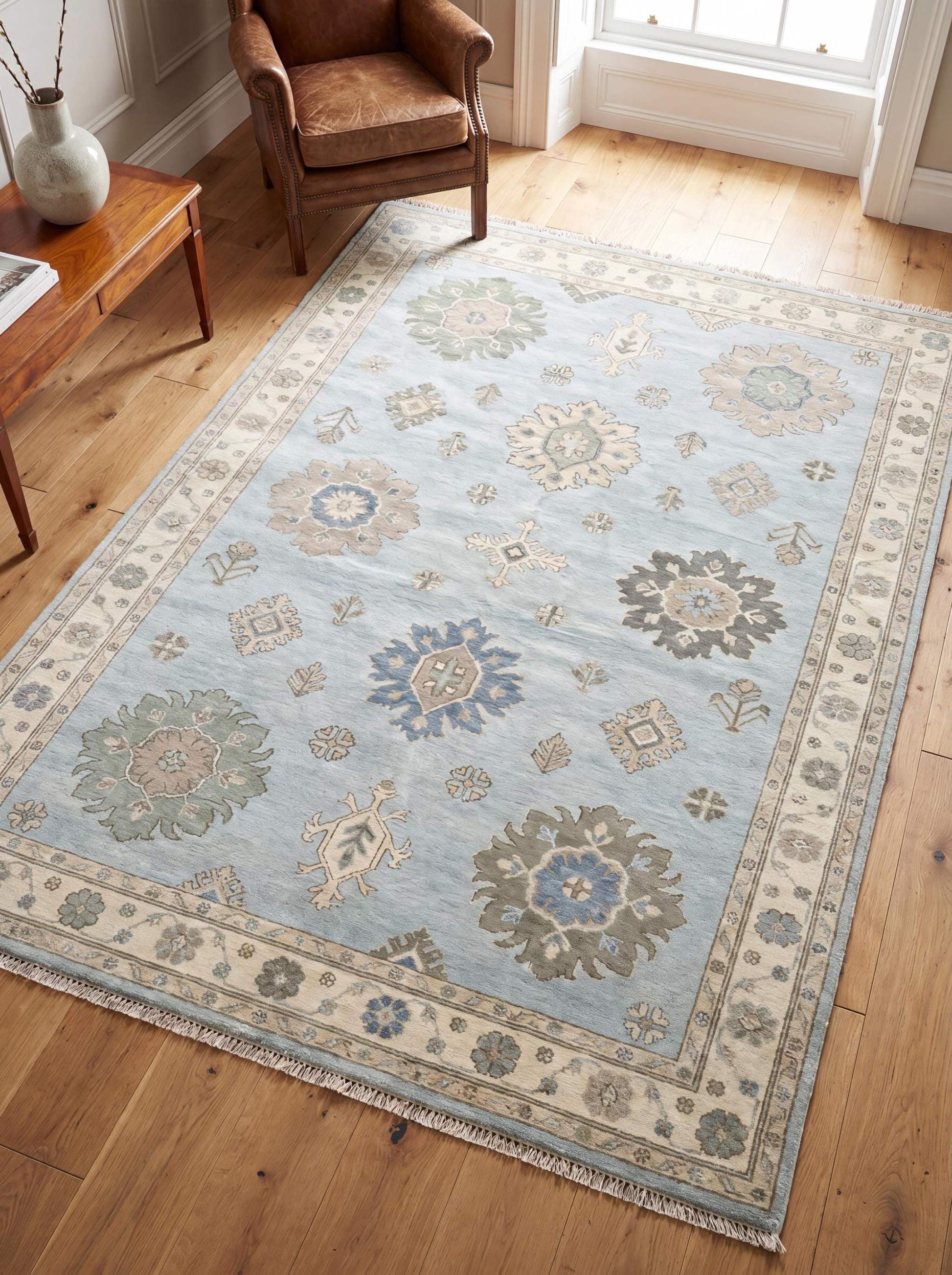 Hand knotted Oushak rug in light blue and ivory with floral medallion motifs styled in a bright living room __etsy:8085160458