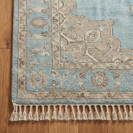 Close up detail of hand-knotted wool pile showing the individual knots and soft texture without latex backing.