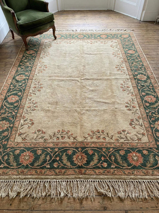 Hand knotted Oushak rug in muted sage green and cream wool with vintage floral design