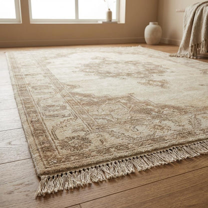 Authentic artisan hand knotted wool carpet with subtle faded pattern and warm earth-tone palette.