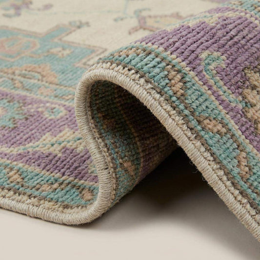 Close up of hand knotted wool rug texture showing individual knot structure, soft wool fibers, and artisan woven pile detail __etsy:7740949004
