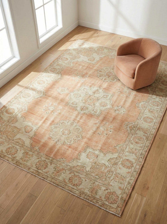 Hand knotted Oushak rug with peach floral medallion and vintage style area design