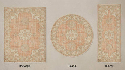 Hand knotted Oushak rug with peach floral medallion and vintage style design on wool fibers