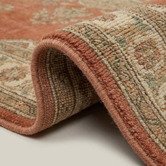 Close-up of hand knotted wool pile showing dense knots, natural fiber texture, and artisan craftsmanship