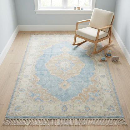 Neutral blue medallion rug with hand tied fringe edges and artisan craftsmanship detail