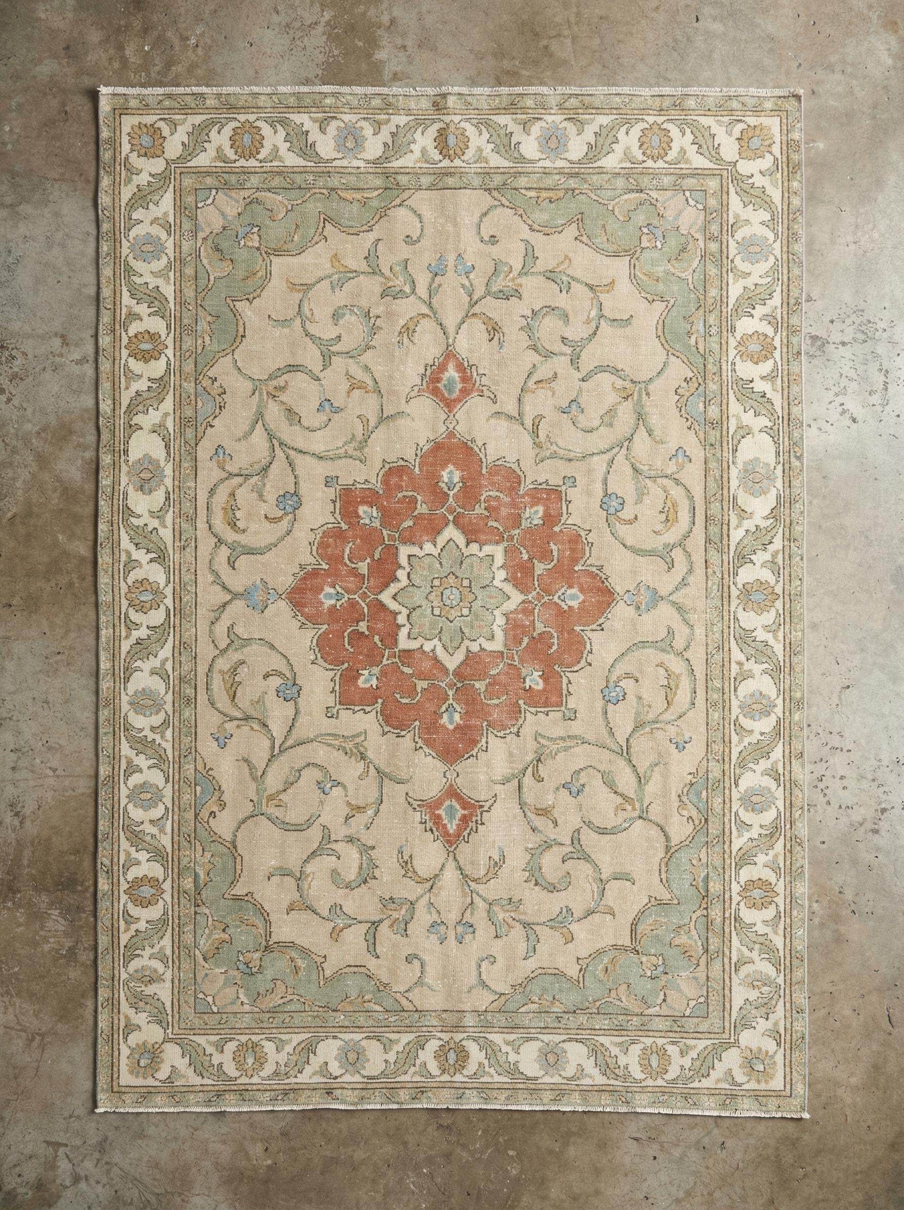 Hand knotted wool rug with floral medallion design and 100% wool pile