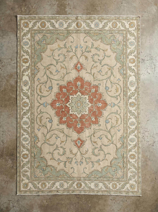 Hand knotted wool rug with floral medallion design and 100% wool pile