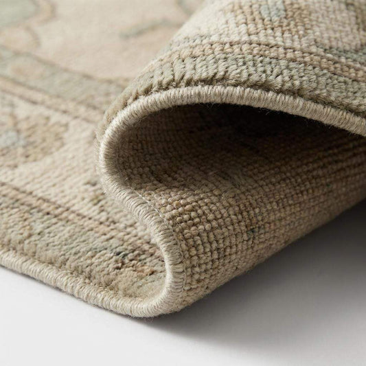 Close-up of hand knotted wool rug showing dense pile, natural wool fibers, and knot structure