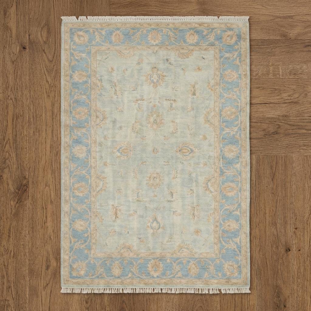 Hand knotted Oushak style wool rug with soft blue vintage floral design, 8x10 and 9x12 sizes.