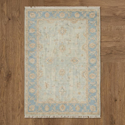 Hand knotted Oushak style wool rug with soft blue vintage floral design, 8x10 and 9x12 sizes.