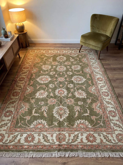 Hand knotted olive green floral Oushak style wool area rug placed in living room with vintage Persian inspired pattern __etsy:7806941718