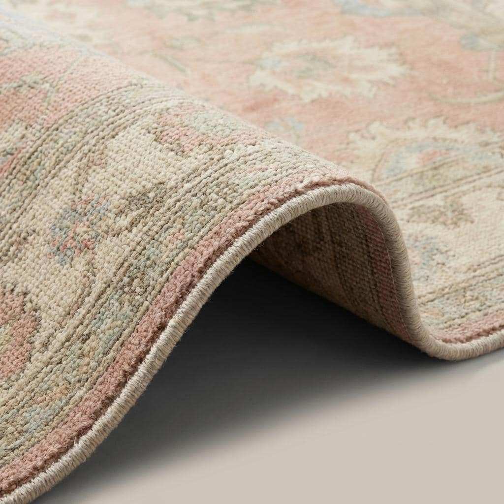 Close-up of hand knotted wool rug showing individual knot structure, natural wool fibers, medium-fine knot density, and low cut pile craftsmanship.