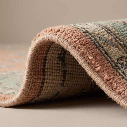Close-up of hand knotted wool rug showing individual knot structure, natural wool fibers, medium pile density, and traditional handwoven craftsmanship.