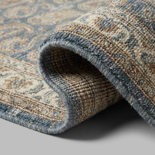 Close-up of hand knotted wool pile showing dense knots, natural fibers, and artisan craftsmanship