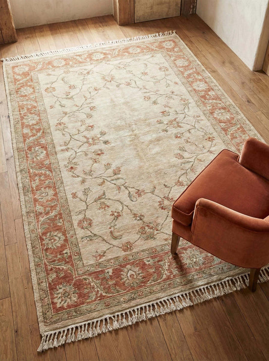 Hand knotted Oushak wool rug with soft floral neutral design in living room