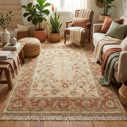 Neutral Oushak style wool rug with blush and sage floral pattern on wooden floor