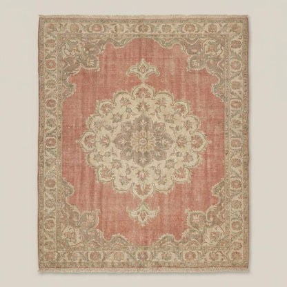 Traditional Oushak rug featuring floral medallion pattern in dusty pink and ivory tones