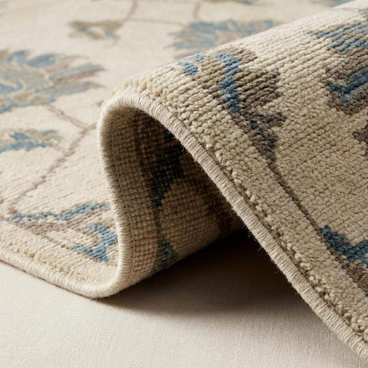 Close-up of hand knotted wool rug showing dense pile, individual knots, and natural wool texture