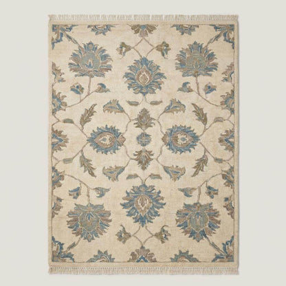 Traditional floral Oushak area rug in muted blue and cream colors with handcrafted wool pile