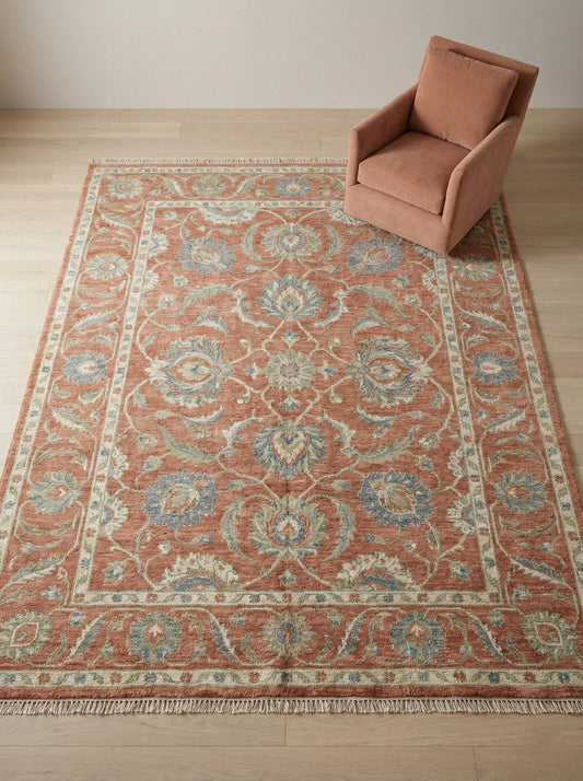 Hand knotted Oushak wool rug with terracotta floral pattern and natural fringe ends