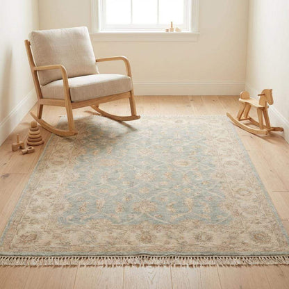 Hand knotted Oushak wool rug in light blue and beige with vintage floral design and low pile for living room.
