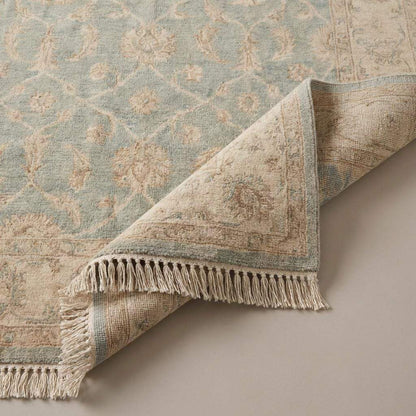 Hand knotted Oushak wool rug in light blue and beige with vintage floral design and soft texture