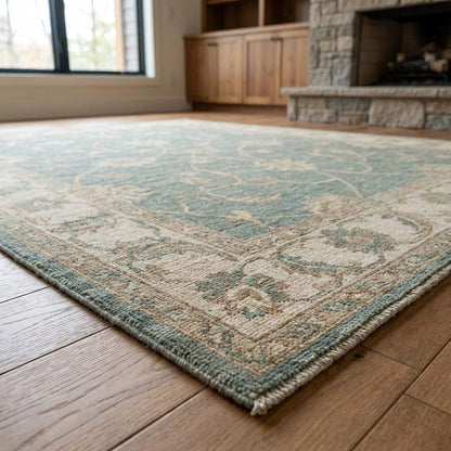 Low pile wool area rug with floral vines and artisan woven details