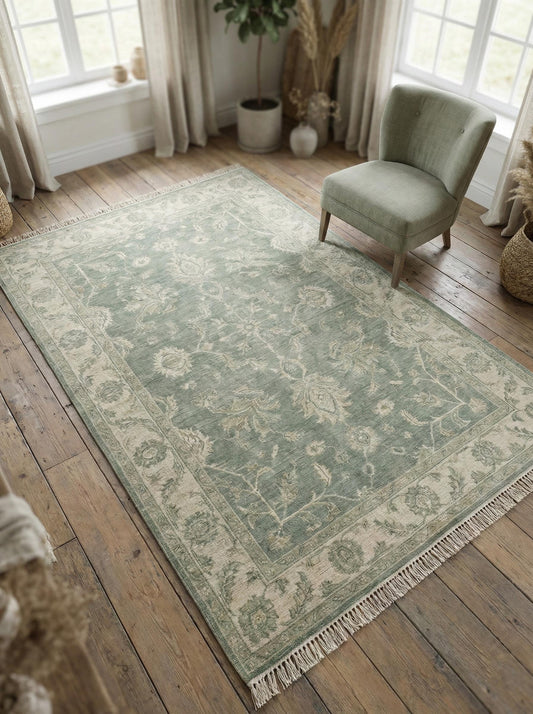 Hand knotted Oushak wool rug with sage green vintage floral design and traditional Persian style