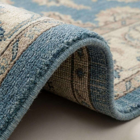 Close-up of hand knotted wool pile showing individual knots, natural wool fibers, and soft texture