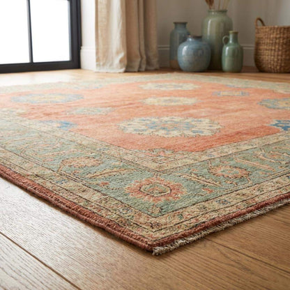 11x12 ft hand knotted wool Oushak rug with floral medallion design in peach and sage green for living room decor