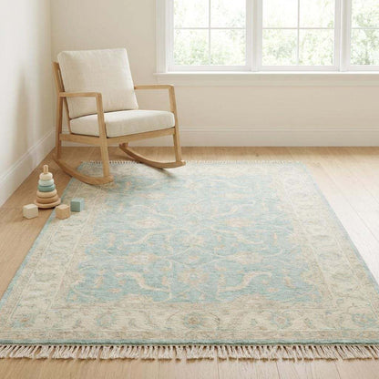 Hand knotted Oushak wool rug with vintage blue floral design in soft neutral living room setting