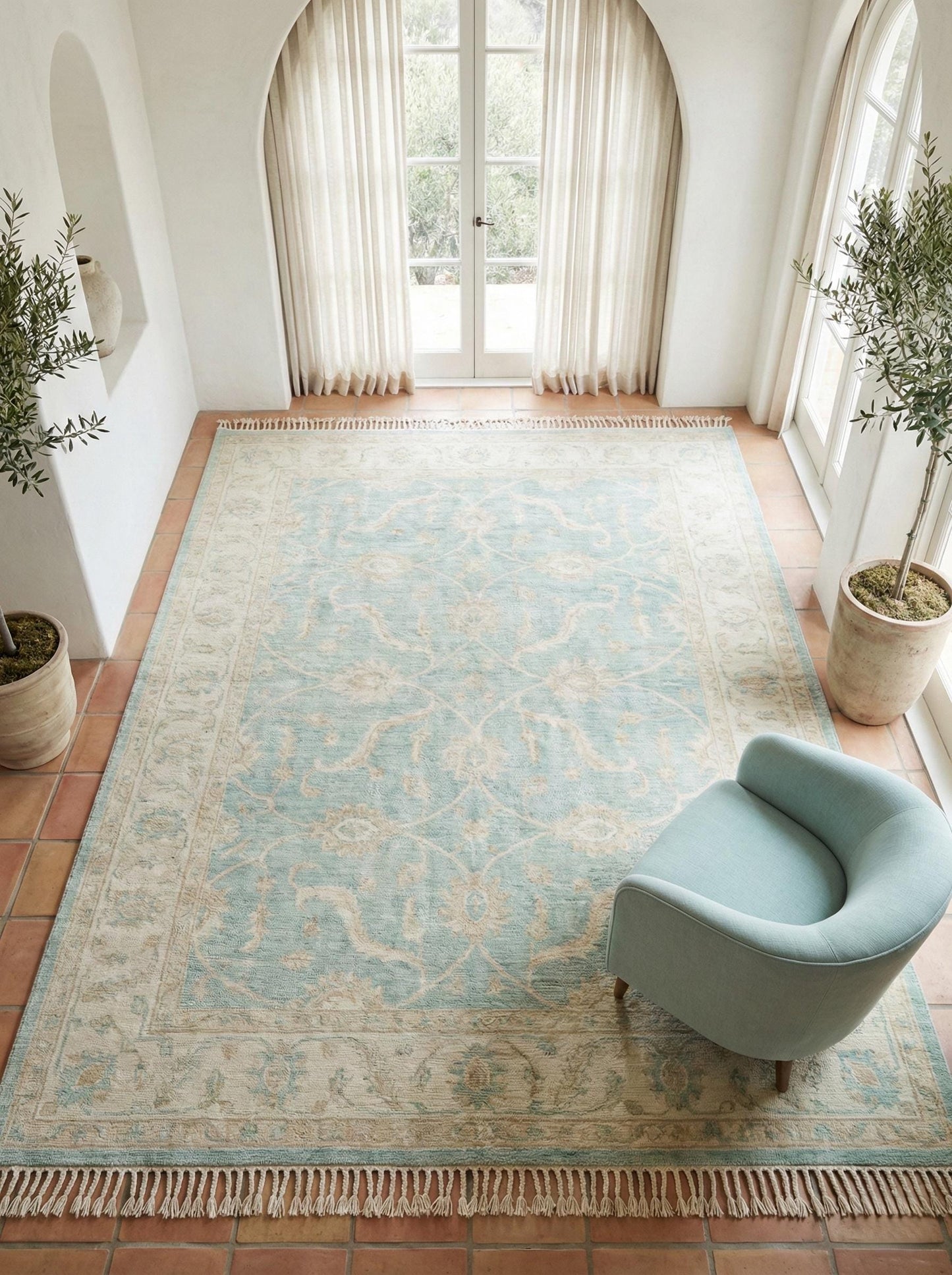 Vintage blue floral hand knotted Oushak wool rug in soft neutral living room setting