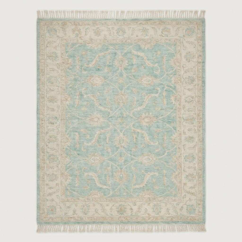 Hand knotted Oushak wool rug with vintage blue floral design in a soft neutral living room setting