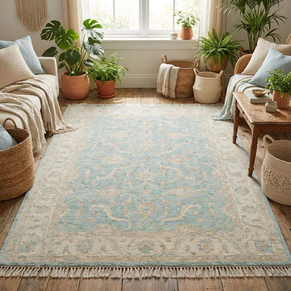 Hand knotted Oushak wool rug with vintage blue floral design in soft neutral living room setting