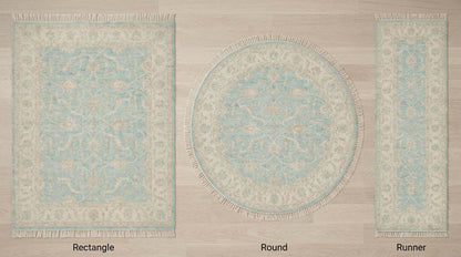 Vintage blue floral hand knotted Oushak wool rug in soft neutral living room setting