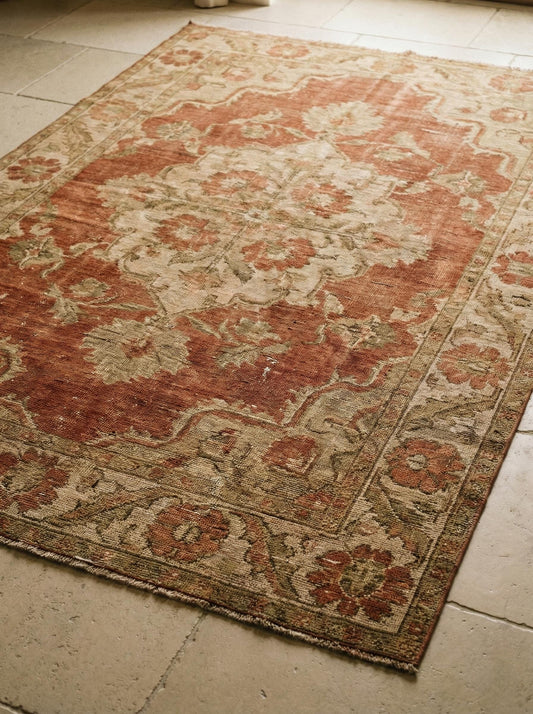 Hand knotted Oushak wool rug with vintage terracotta floral design and soft wool pile