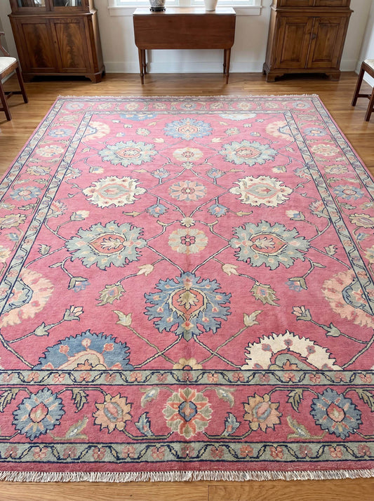 Hand knotted pink Oushak rug with vintage floral medallion design placed in a traditional living room interior __etsy:8071433892