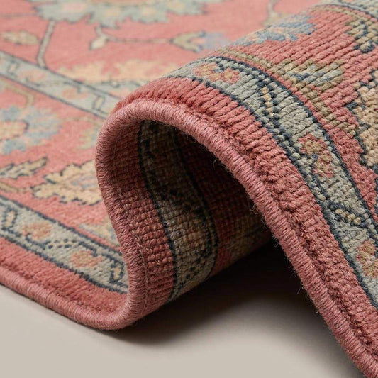 Close-up of handmade wool pile showing hand-knotted texture, soft fibers, detailed floral motifs, and low pile construction __etsy:8071434880