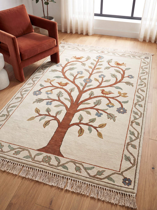Hand knotted tree of life rug with floral vines and birds in neutral wool tones styled in modern living room __etsy:7917706136