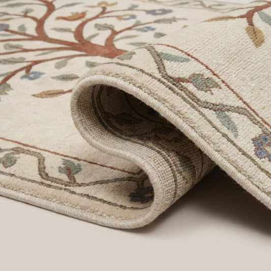 Close-up of hand knotted wool rug showing dense knot structure, soft pile texture, and detailed floral bird pattern __etsy:7965657201