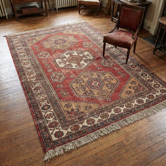 Hand knotted tribal wool area rug with geometric medallion design and natural wool pile