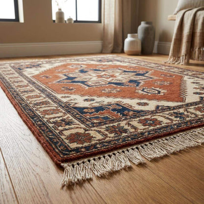 Artisan made tribal wool rug with earthy rust, ivory, and blue color palette